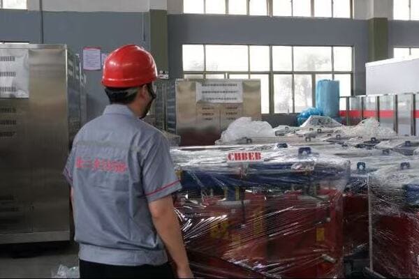 Image of engineers reviewing and correcting transformer diagrams on-site